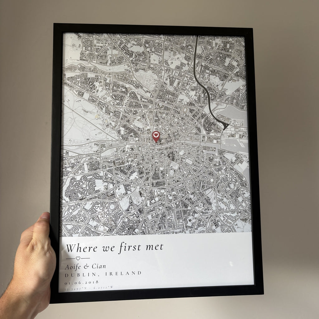 Hand holding a framed custom map poster to show its size