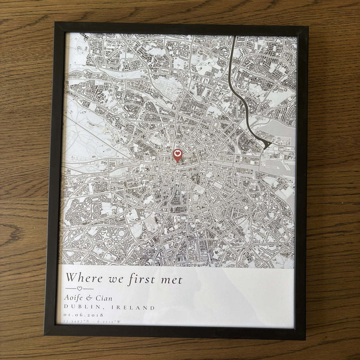 Personalised Dublin map poster in a black frame, flat on a wooden table